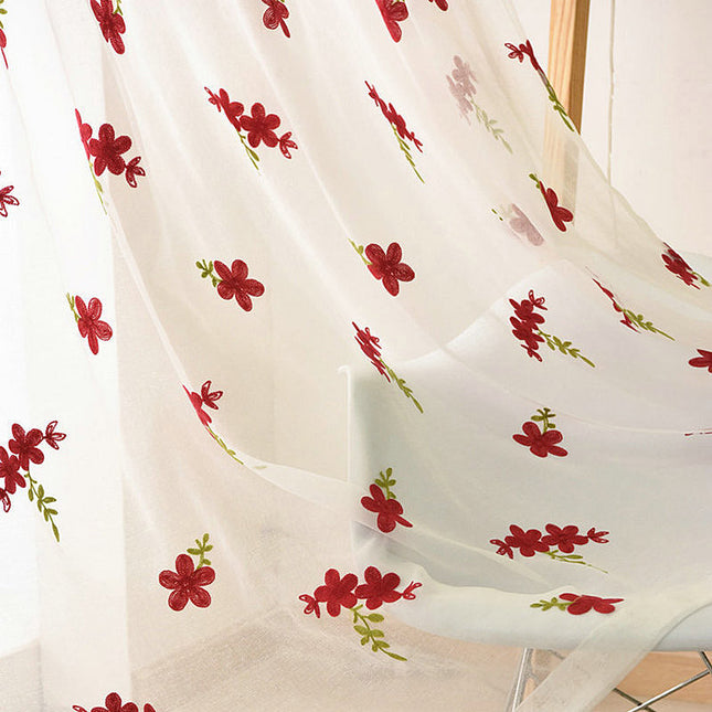 Voile ricamato con piccoli fiori rossi