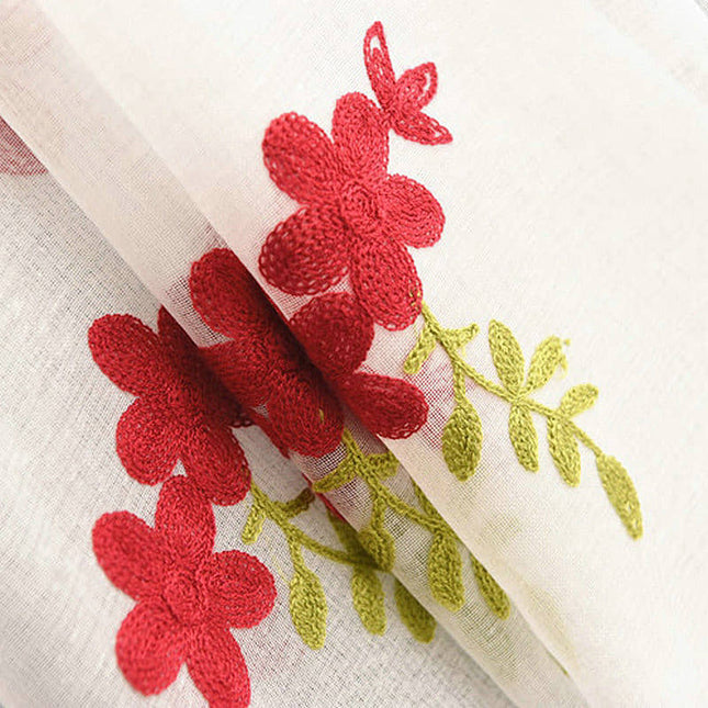 Voile ricamato con piccoli fiori rossi